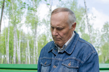 Naklejka na ściany i meble Aged man is making notes in the daily planner