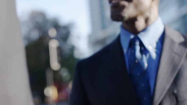 4K Two business men meet and talk in the street briefly, in slow motion