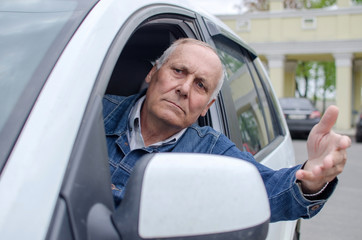 Aged man  sitting in the car