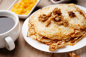 Pancakes with walnuts, jam and coffee 