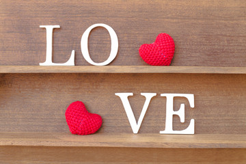words " love " and heart shaped fabric