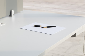 Pen and paper on the office table