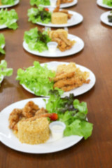 blurred of food, fried rice and breaded fried chicken in white p