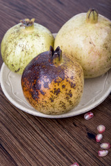 Pomegranate and seeds on the table