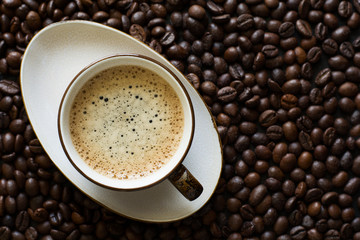 Cup of coffee on beans