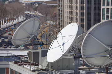Parabolic satellite dish space technology receivers over the city, Toronto, Canada