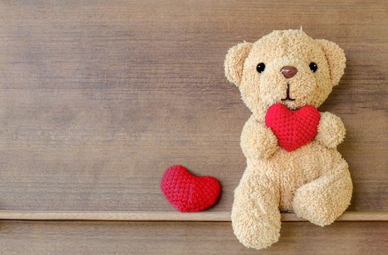 Teddy Bear Holding A Heart-shaped Pillow