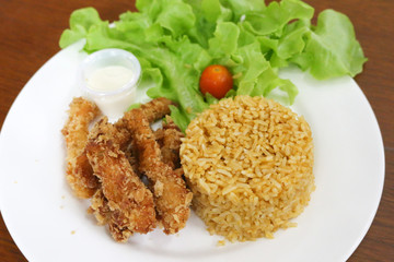 fried rice and breaded fried chicken in white plate
