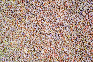 Small multicolored stone gravel covered surface fragment as abstract background texture