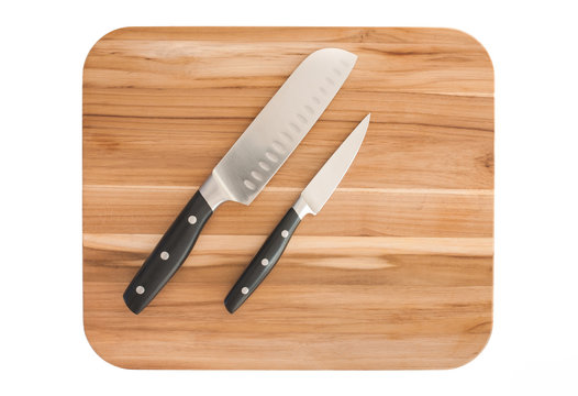 Knives on cutting board. Isolated on white.
