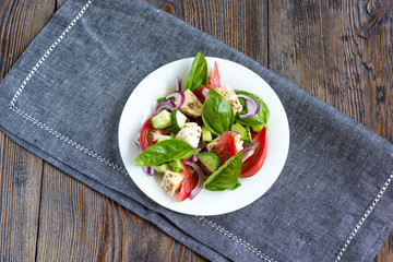 Fresh Greek salad on a plate, top view