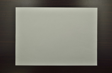 Blank White Paper on Wood Background With Shadow