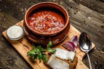 Ukrainian borsch soup and garlic buns on the table.