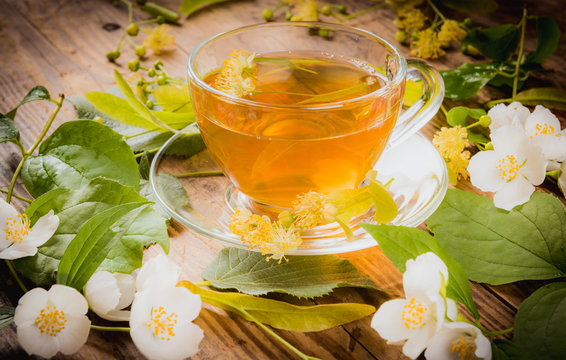 Cup of tea linden jasmine on wooden background