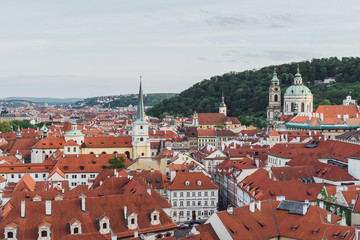 Obraz premium Prague cityscape in spring. Top view of old city center ang orange roofs.