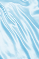 Fototapeta na wymiar Smooth elegant blue silk or satin as background