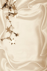 Golden stars and spangles on silk as background. In Sepia toned.