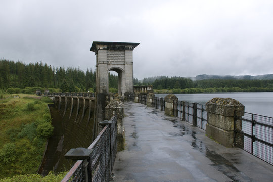 Alwen reservoir, Wales, UK wet day showing bridge accross dam and green trees and plants