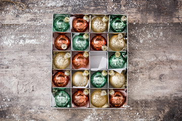 Christmas balls in box on rustic wooden background

