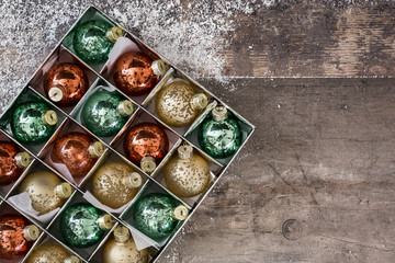 Christmas balls in box on rustic wooden background

