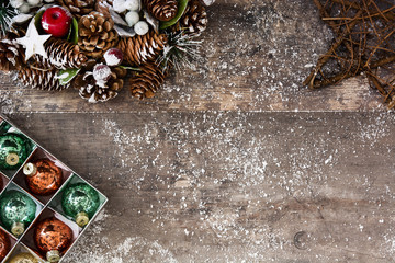 Christmas balls in box on rustic wooden background
