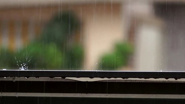 raindrop falling on balcony balustrade and splashes water heavy rain