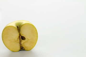 Sliced green apples on a white table.