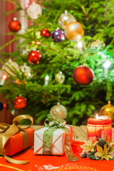 Fototapeta na wymiar Decorated and illuminated Christmas tree on indistinct, blurred and fairytale background. 