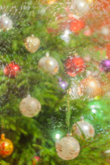 Obraz na płótnie Canvas Decorated and illuminated Christmas tree on indistinct, blurred and fairytale background. 