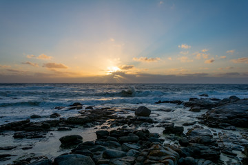 Sundown in Cape Town, South Africa with splashing waves