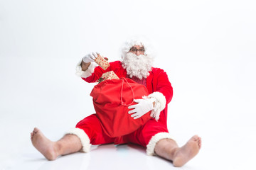  Portrait of happy Santa Claus holding  Christmas gifts