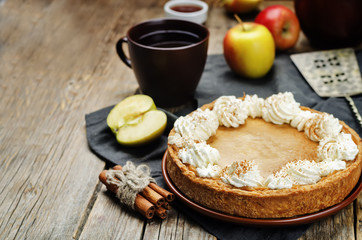 Obraz na płótnie Canvas apple pie decorated with whipped cream