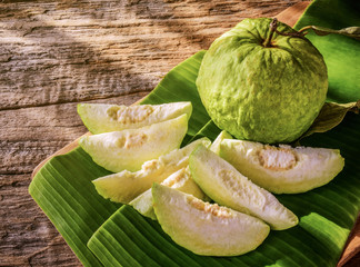 Guava,prepared for serving on banana leaves background.Fresh guava contains high level of vitamin...