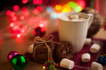 Homemade chocolate cookies with cup of cocoa and marshmallow. Christmas hot drink with tasty cookies.