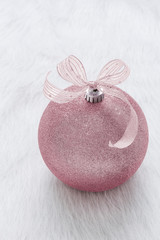One beautiful, fancy,  perfect, sparkly, shiny, pink glitter Christmas ornament on vertical white background