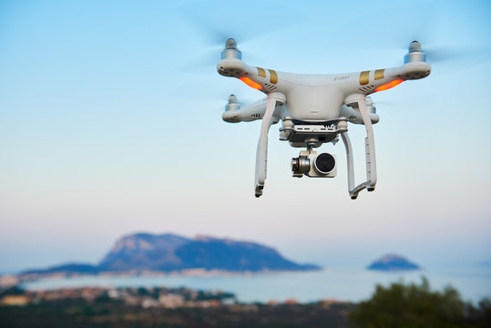 uav drone with digital camera hover sea island