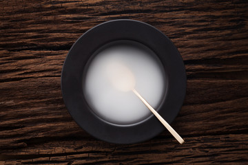 black empty bowl spoon on wooden table background