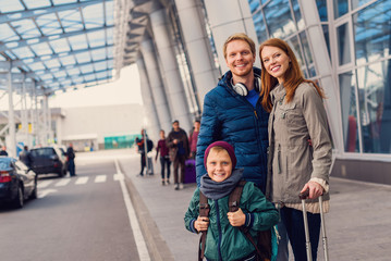 Smiling family with child at airport
