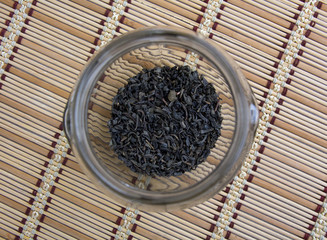 Green tea leaves in the glass jar