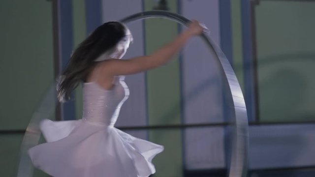 Professional circus performer rotate on cyr wheel