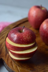 fresh red apples on a wooden tray