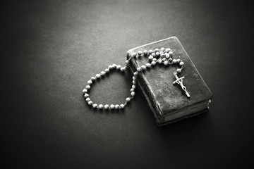 Rosary on the old Bible 