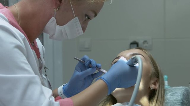 Medical dentist procedure of teeth polishing with cleaning from dental deposit and odontolith
