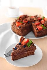 Delicious chocolate cake with strawberry on plate