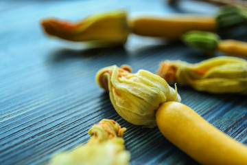 Fresh yellow zucchini on wooden background, closeup