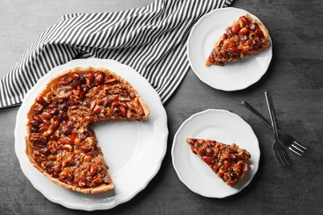 Delicious cake with nuts on table