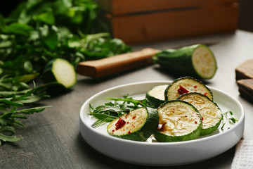 Baked squash slices in plate on table