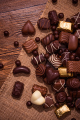 Assorted chocolates on wooden background