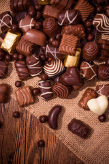 Assorted chocolates on wooden background
