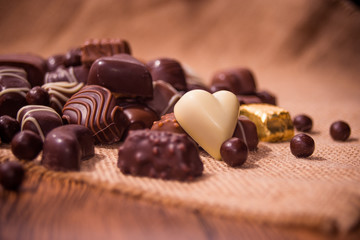 Assorted chocolates on wooden background